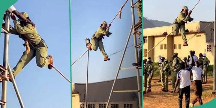 A Lady Is Seen Climbing A Rope At NYSC Camp During Man O’ War Drill